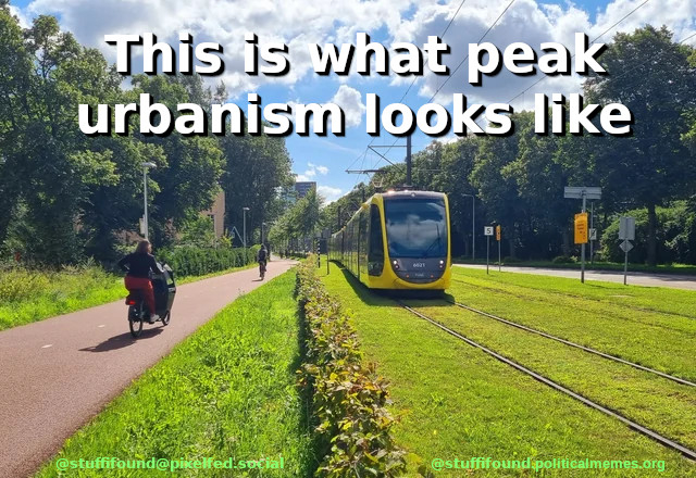 Picture of a tram lane in grass and a yellow tram, and next to the tram lane a bike lane with some cyclists. On the side you can see lots of trees, in the distance some skyscrapers are visible. The picture is captioned "This is what peak urbanism looks like"